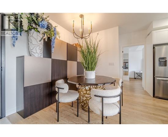 A dining area with a round table and chairs.