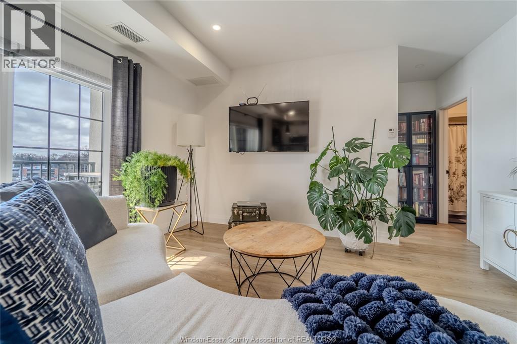 A living room with a white couch and a wooden coffee table.