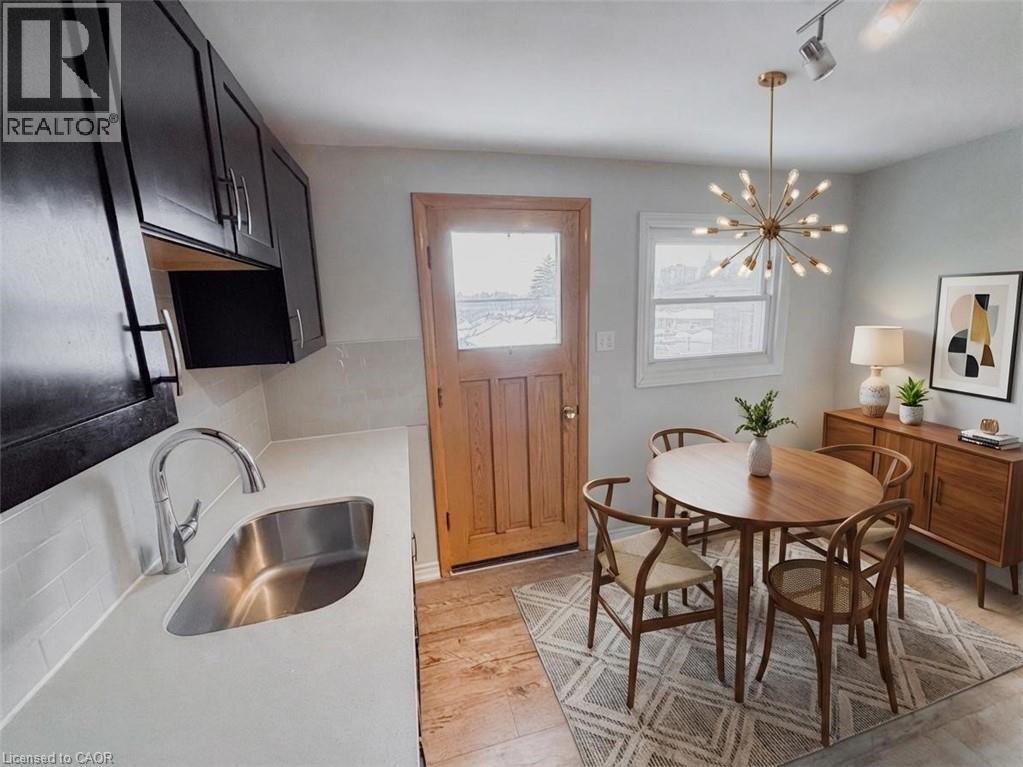 A kitchen with a sink and a dining table.