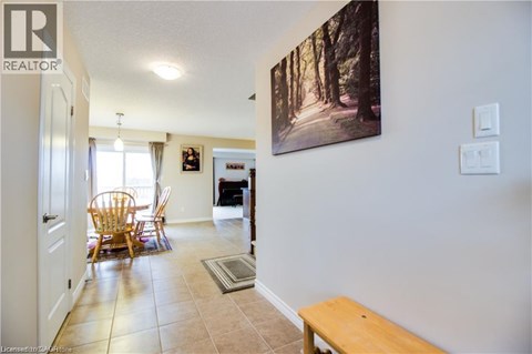 A living room with a wooden bench and a painting on the wall.