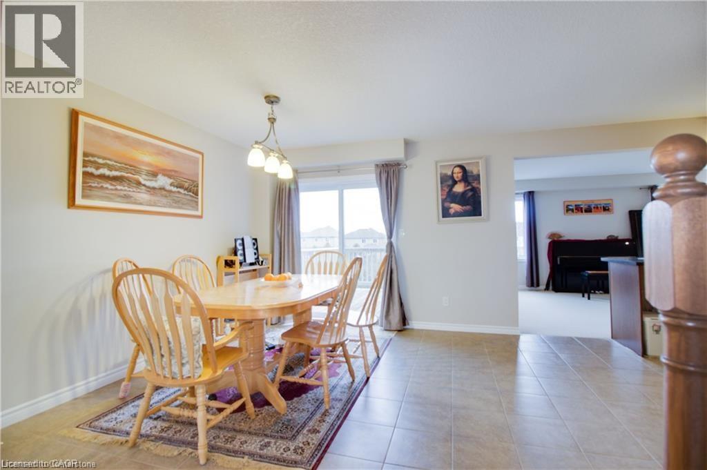 A dining room with a wooden table and chairs.