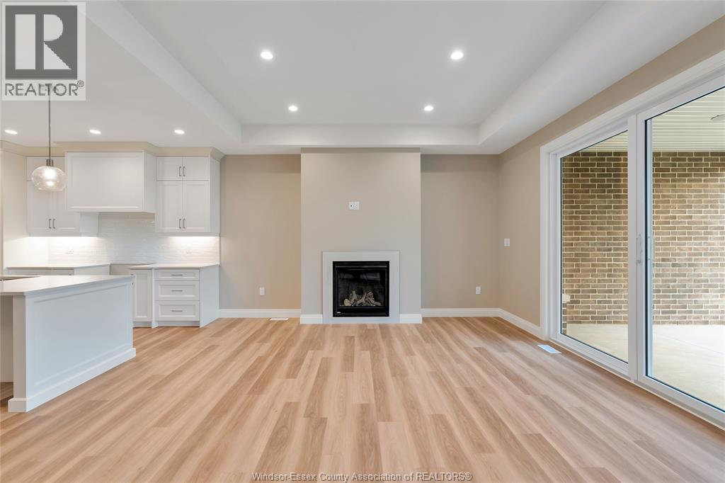 A spacious living room with a fireplace and sliding glass doors.