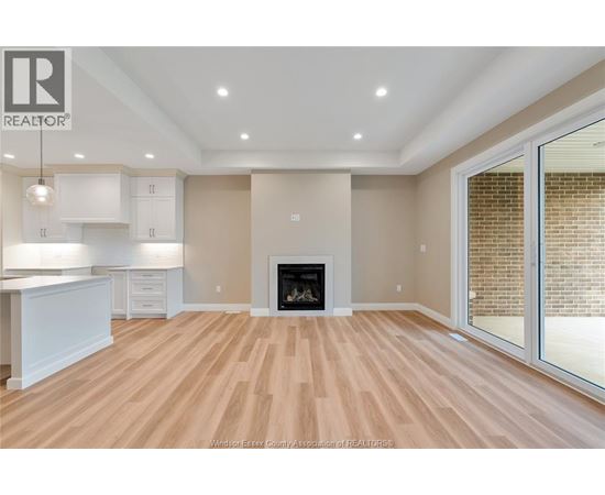 A spacious living room with a fireplace and sliding glass doors.