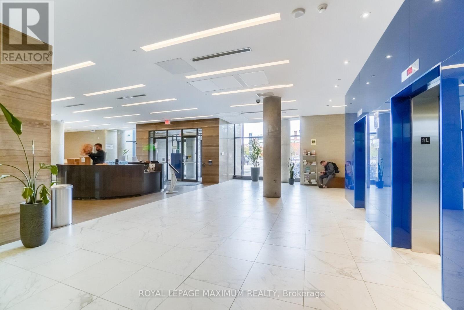 A spacious room with tables and chairs is ready for a business meeting.
