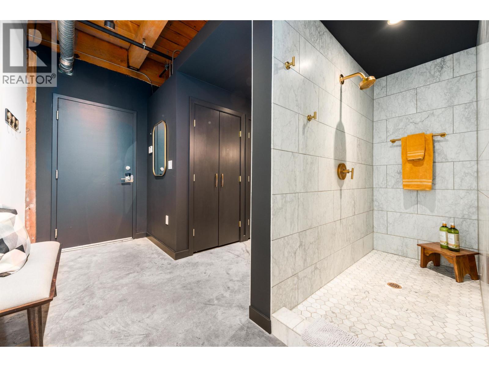 A bathroom with a shower and a toilet.