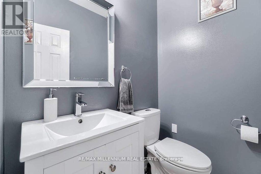 A bathroom with a white sink and toilet.