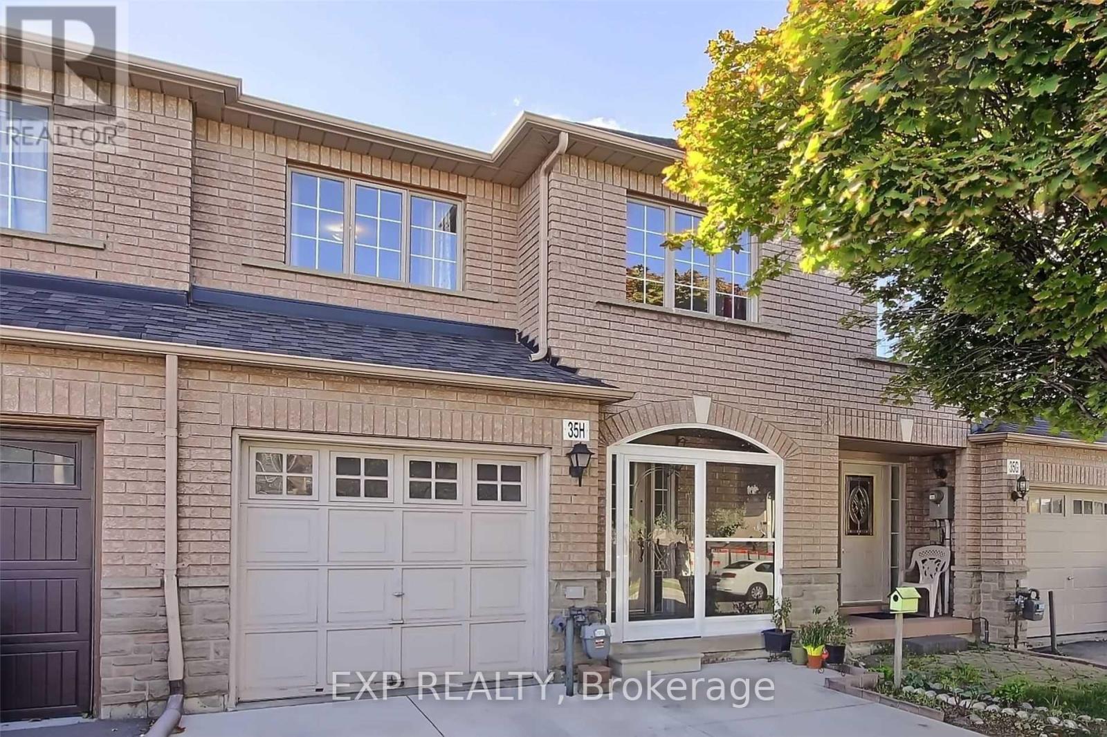A house with a brown garage door is for sale.