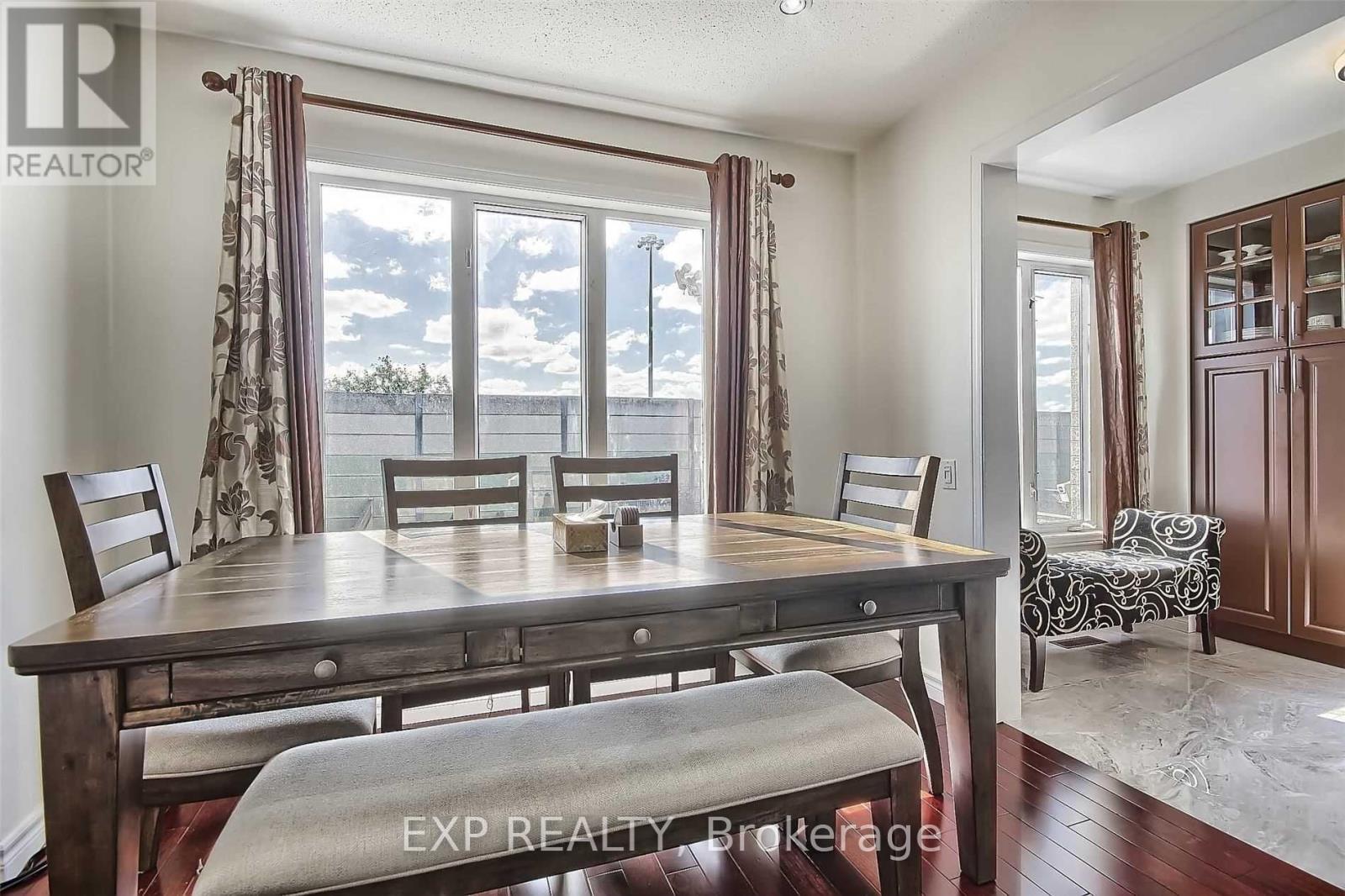 A dining room with a wooden table and chairs.