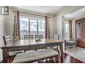 A dining room with a wooden table and chairs.
