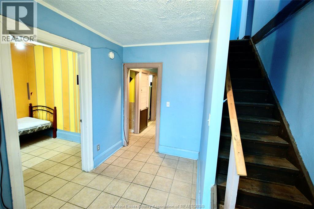 A bedroom with a bed and a staircase.