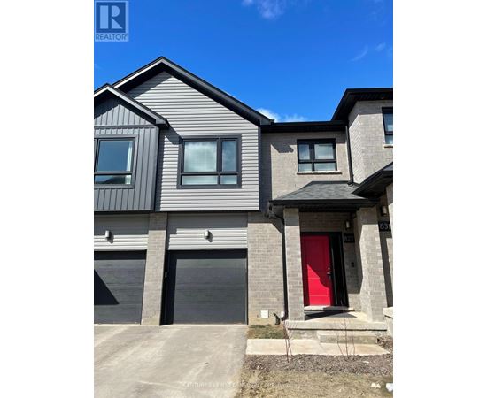 A modern house with a red door is for sale.