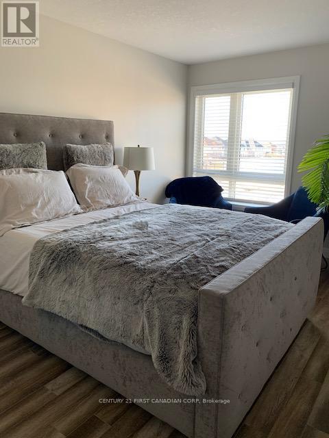 A bedroom with a large bed and a window.