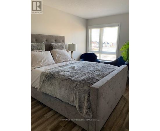 A bedroom with a large bed and a window.