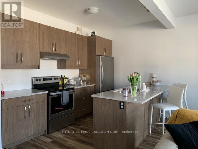 A kitchen with wooden cabinets and a black stove top oven.
