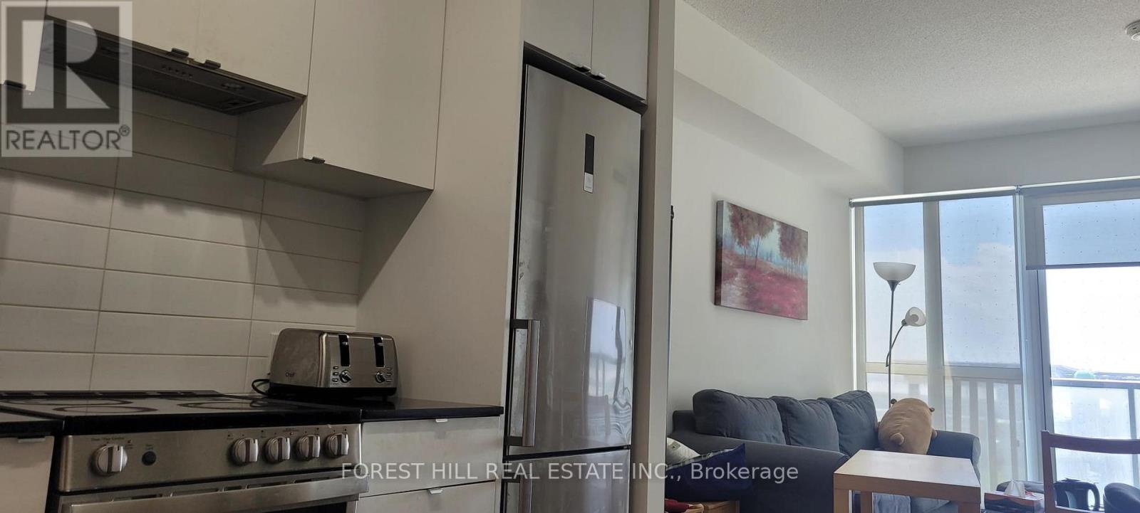 A modern kitchen with Forest Hill Real Estate Inc. logo on the stove.