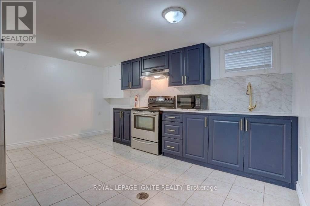 A kitchen with dark blue cabinets and white appliances.