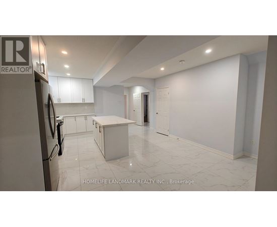 A kitchen with white cabinets and a marble floor.