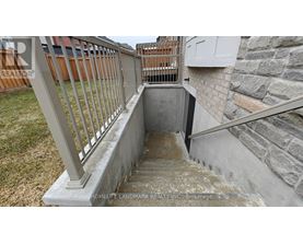 A concrete staircase with a metal railing.