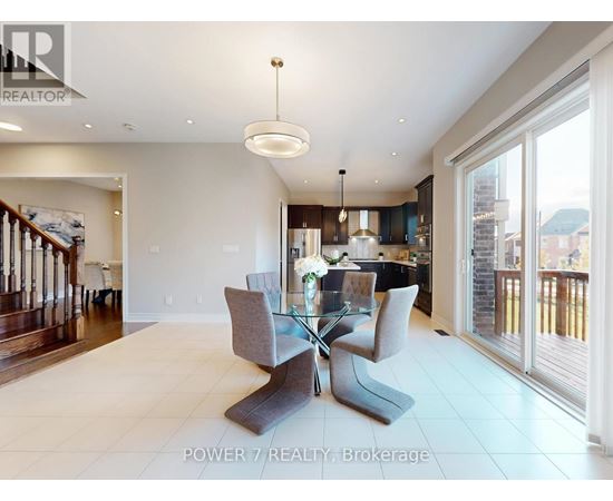 A modern dining room with a glass table and grey chairs.