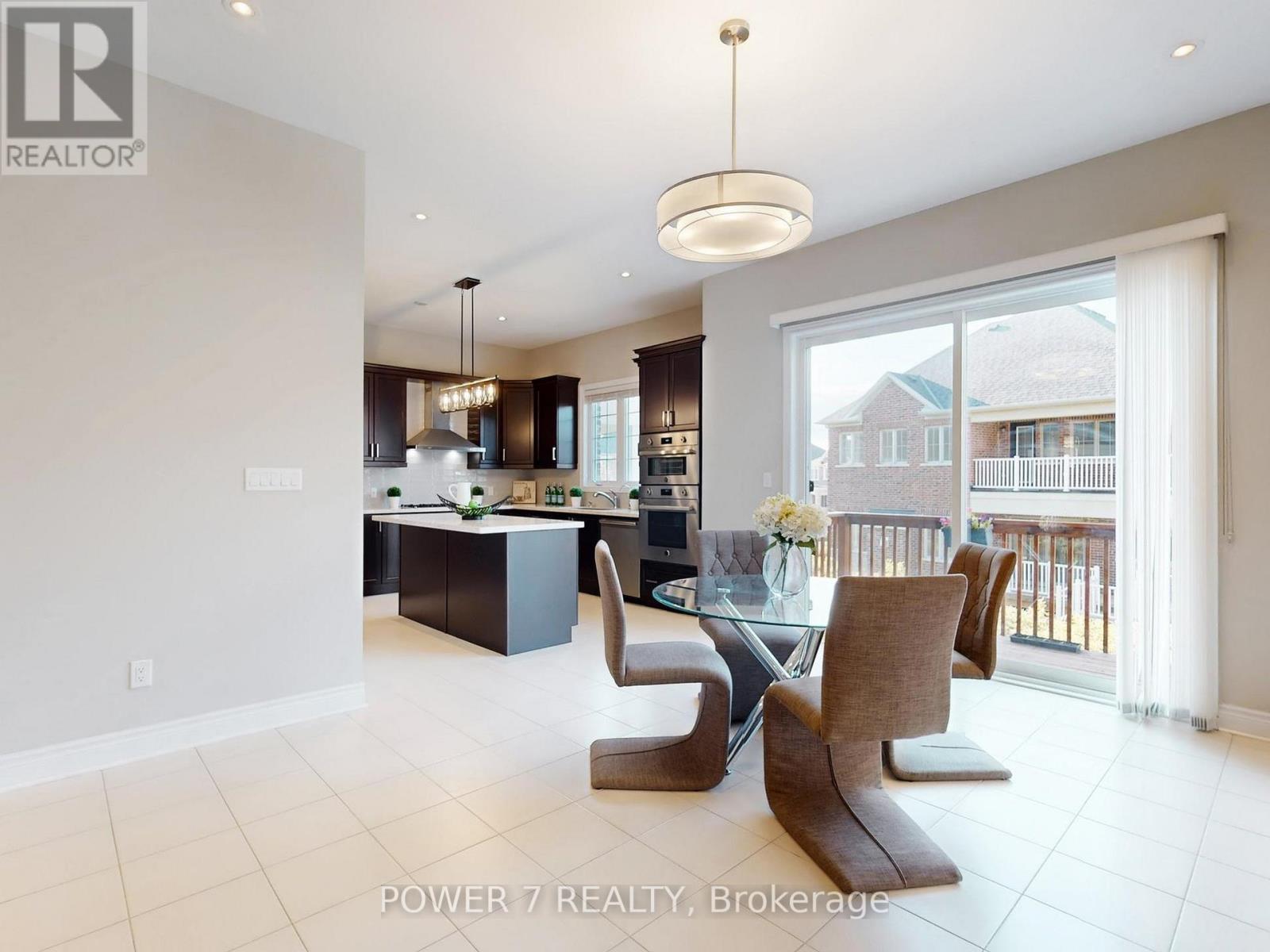 A modern kitchen with a dining table and chairs.