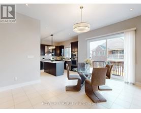 A modern kitchen with a dining table and chairs.