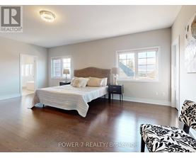 A bedroom with a large bed and a chair.
