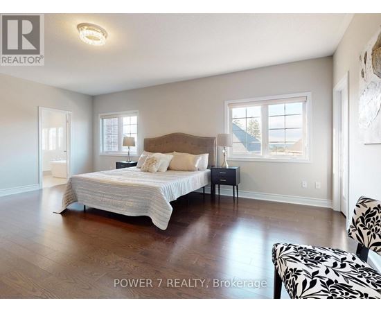 A bedroom with a large bed and a chair.