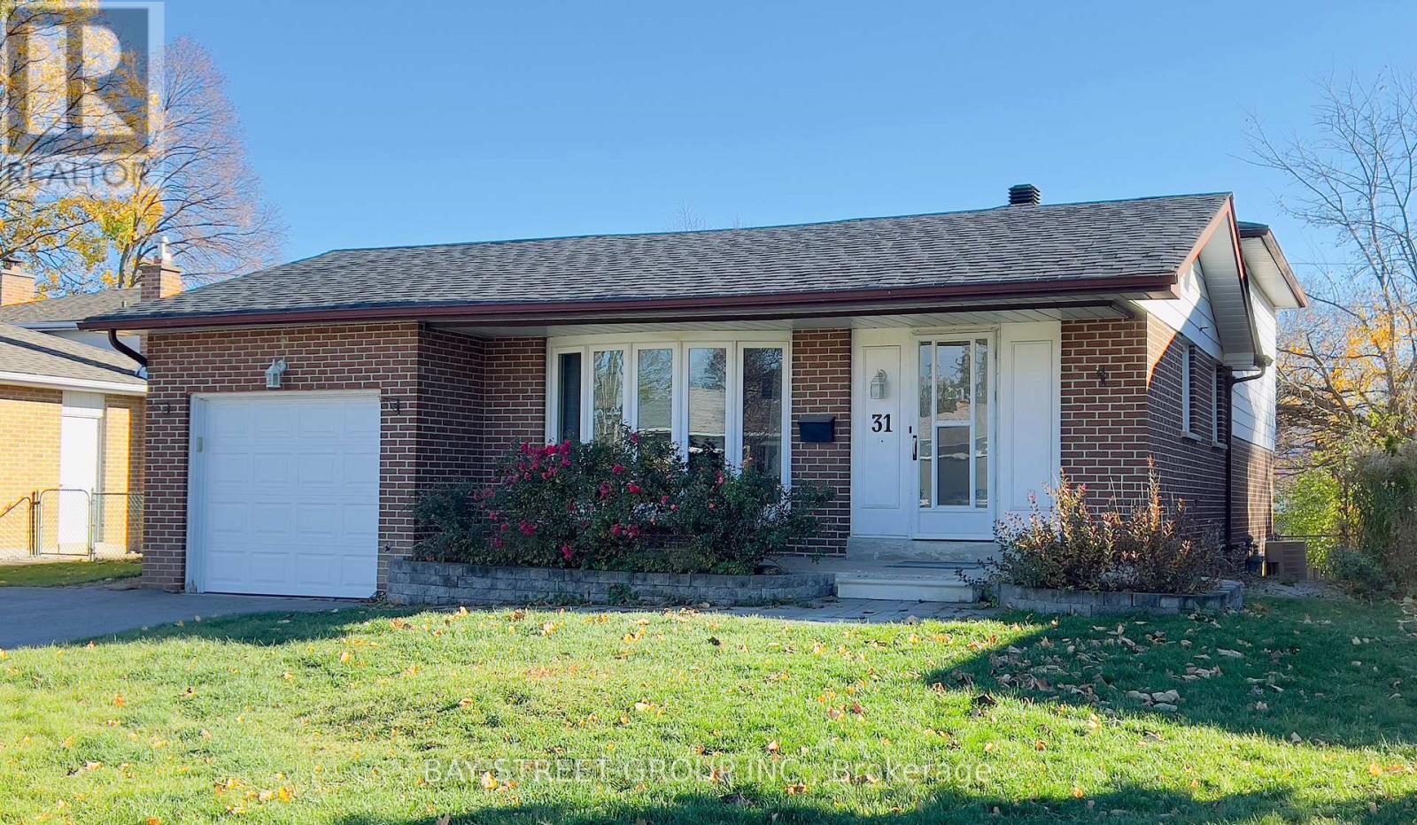 A house with a white door and windows is surrounded by a green lawn.