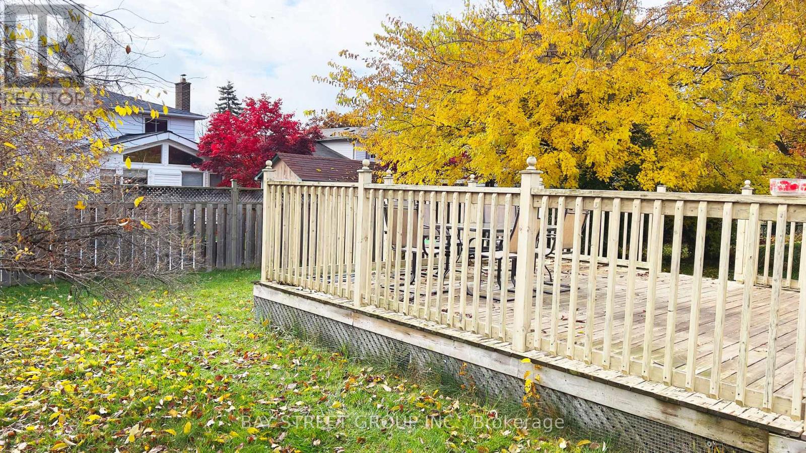 A wooden bridge over a grassy area with trees in the background.