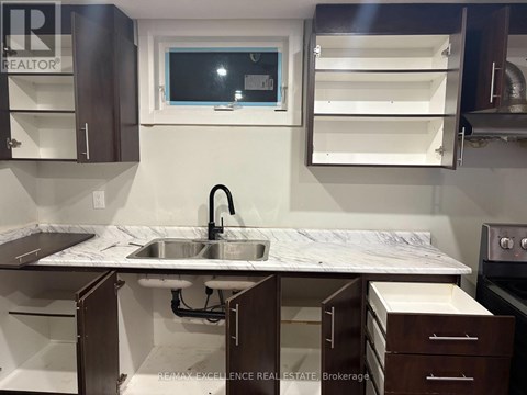 A kitchen with a sink and a window.