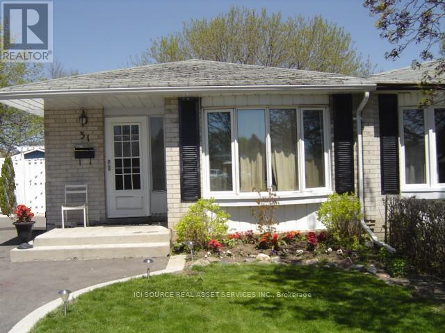 A house with a white door and black shutters is shown.