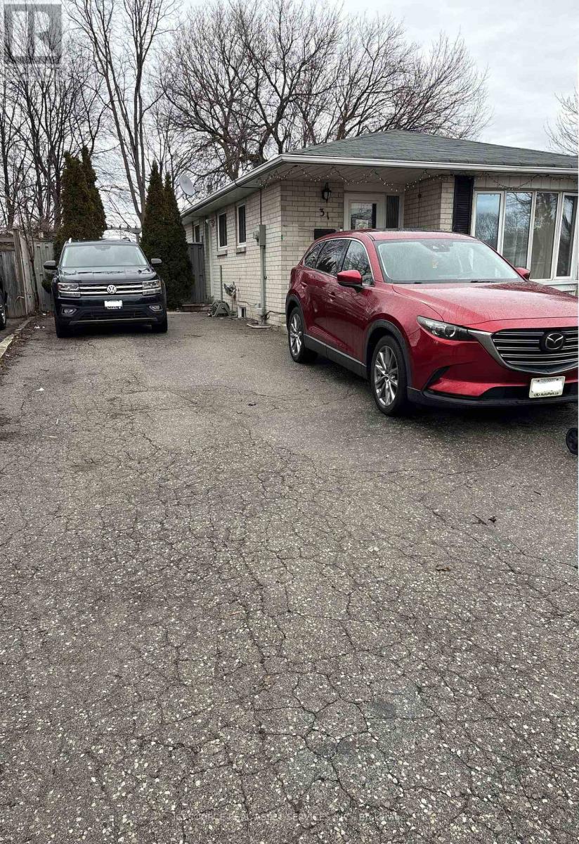 A red car is parked in front of a house.