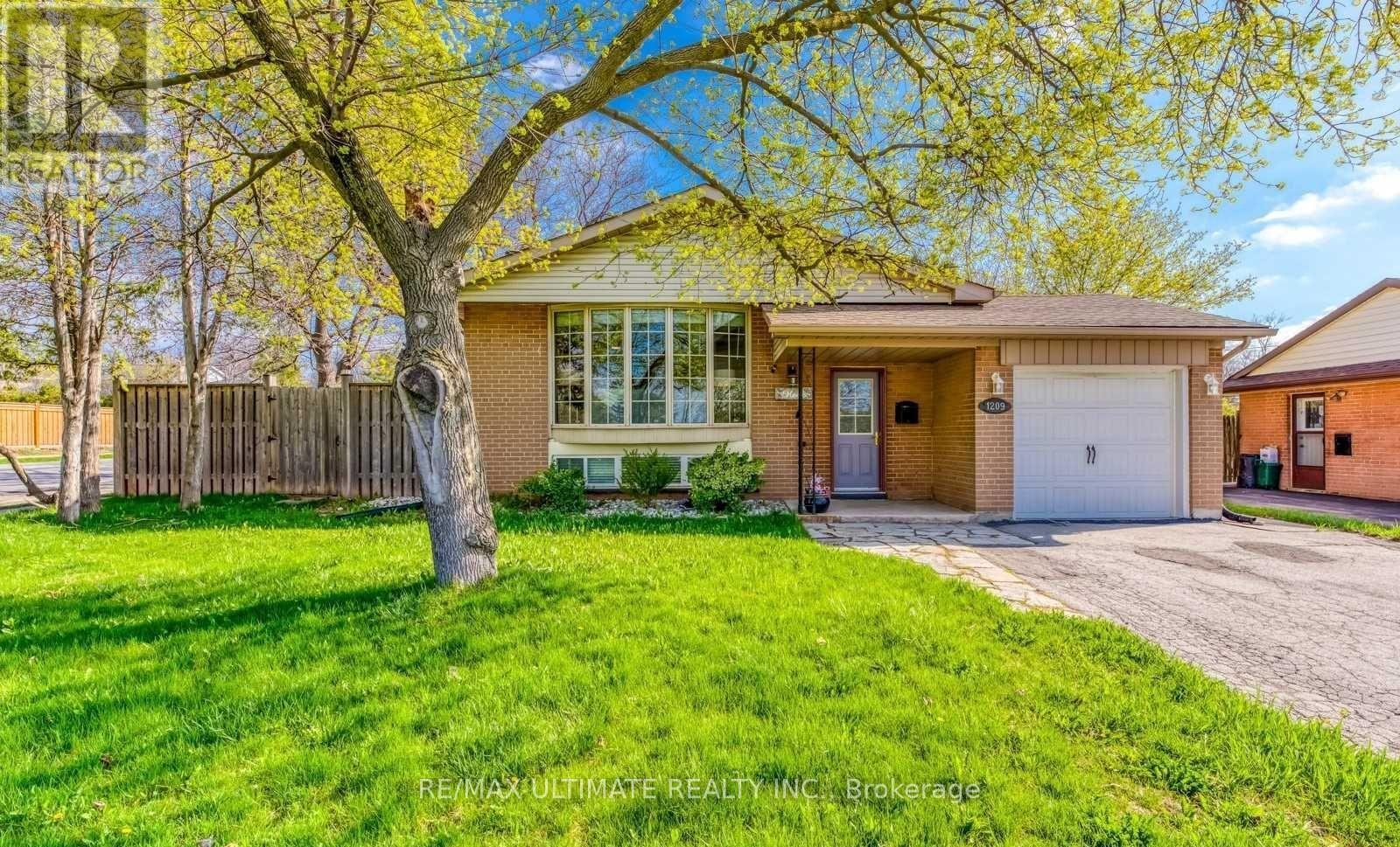 A house with a tree in front of it.