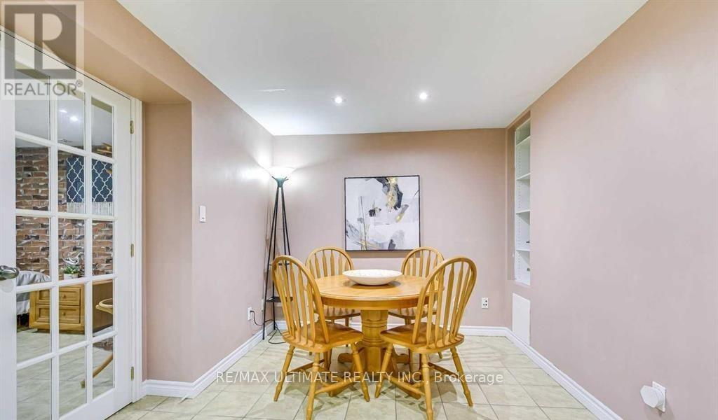 A dining room with a wooden table and chairs.