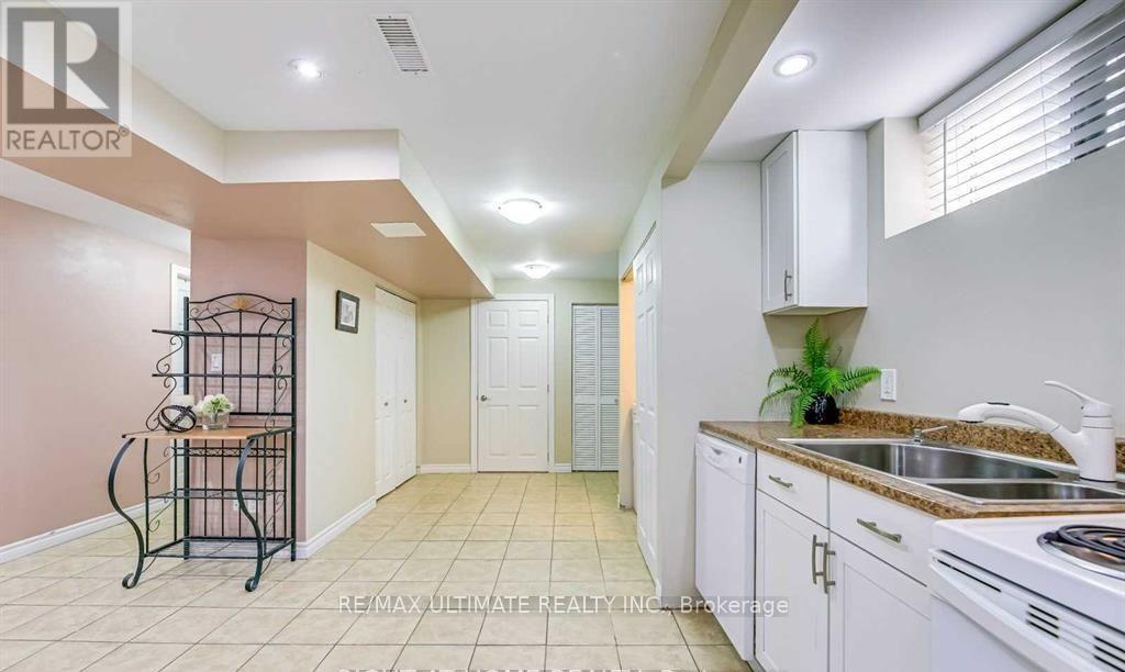 A kitchen with white cabinets and a sink.