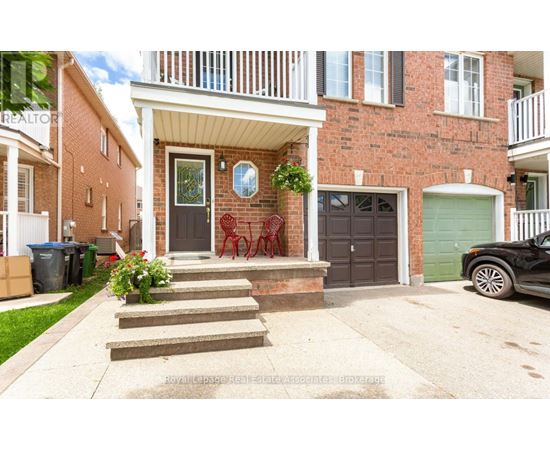 A house with a red brick facade and a white porch.