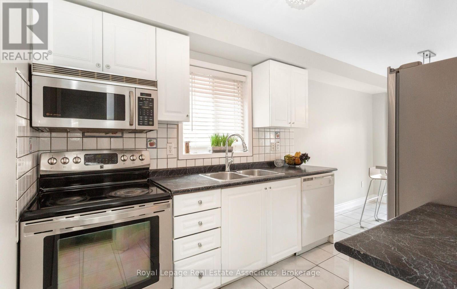 A kitchen with a stove, microwave, and oven.