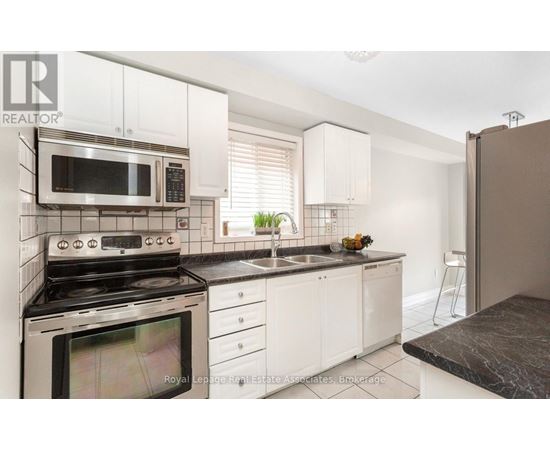 A kitchen with a stove, microwave, and oven.