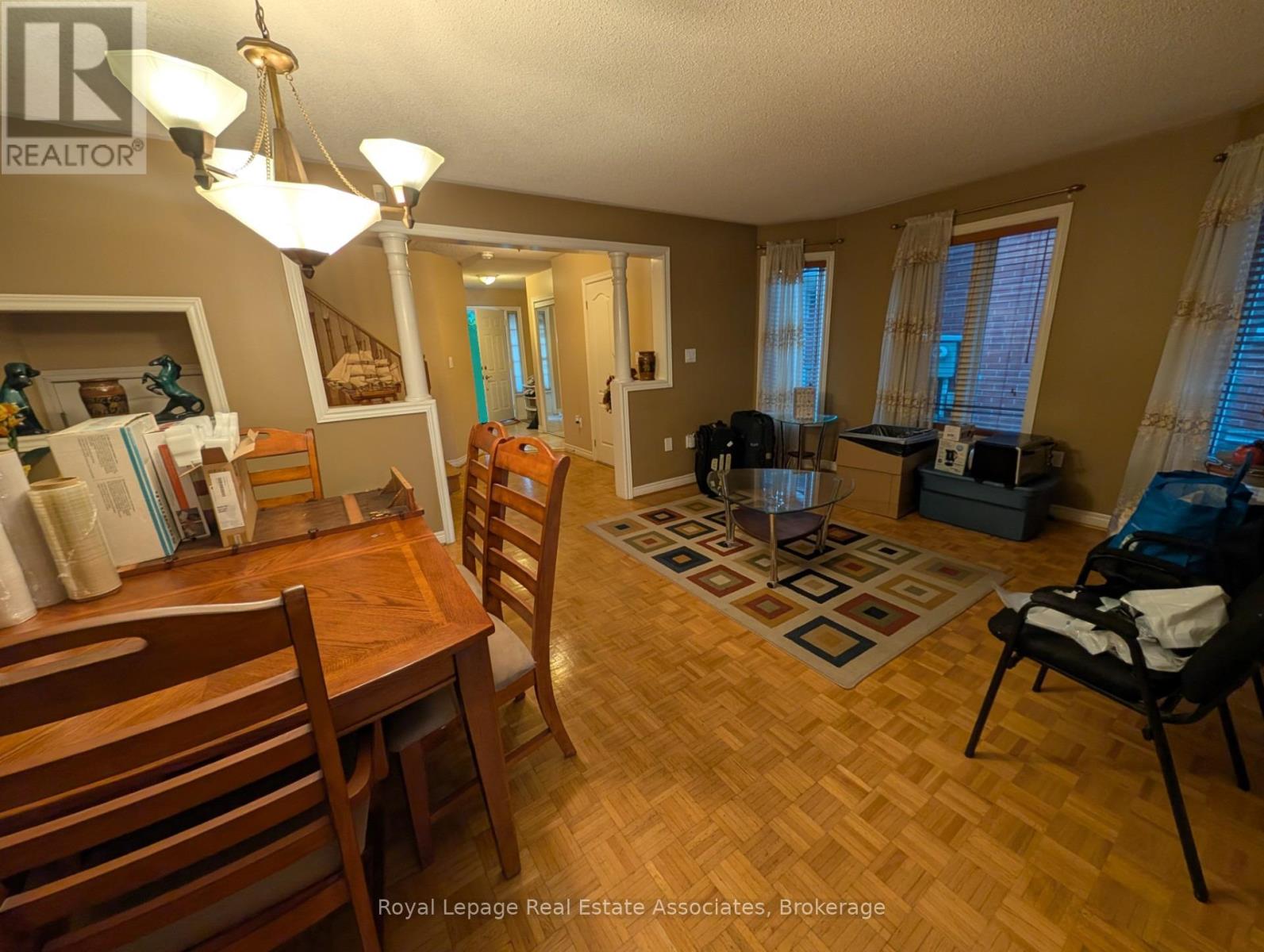 A dining room with a wooden table and chairs.