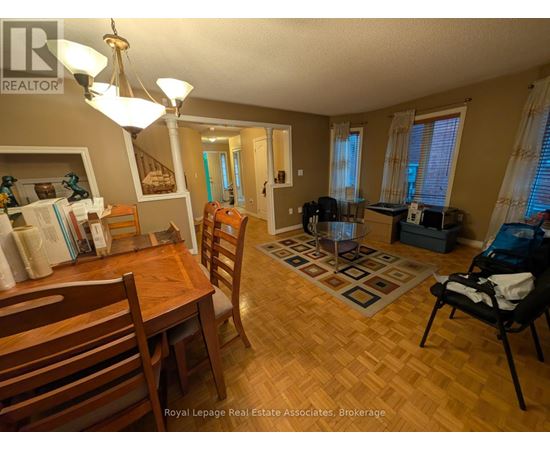 A dining room with a wooden table and chairs.