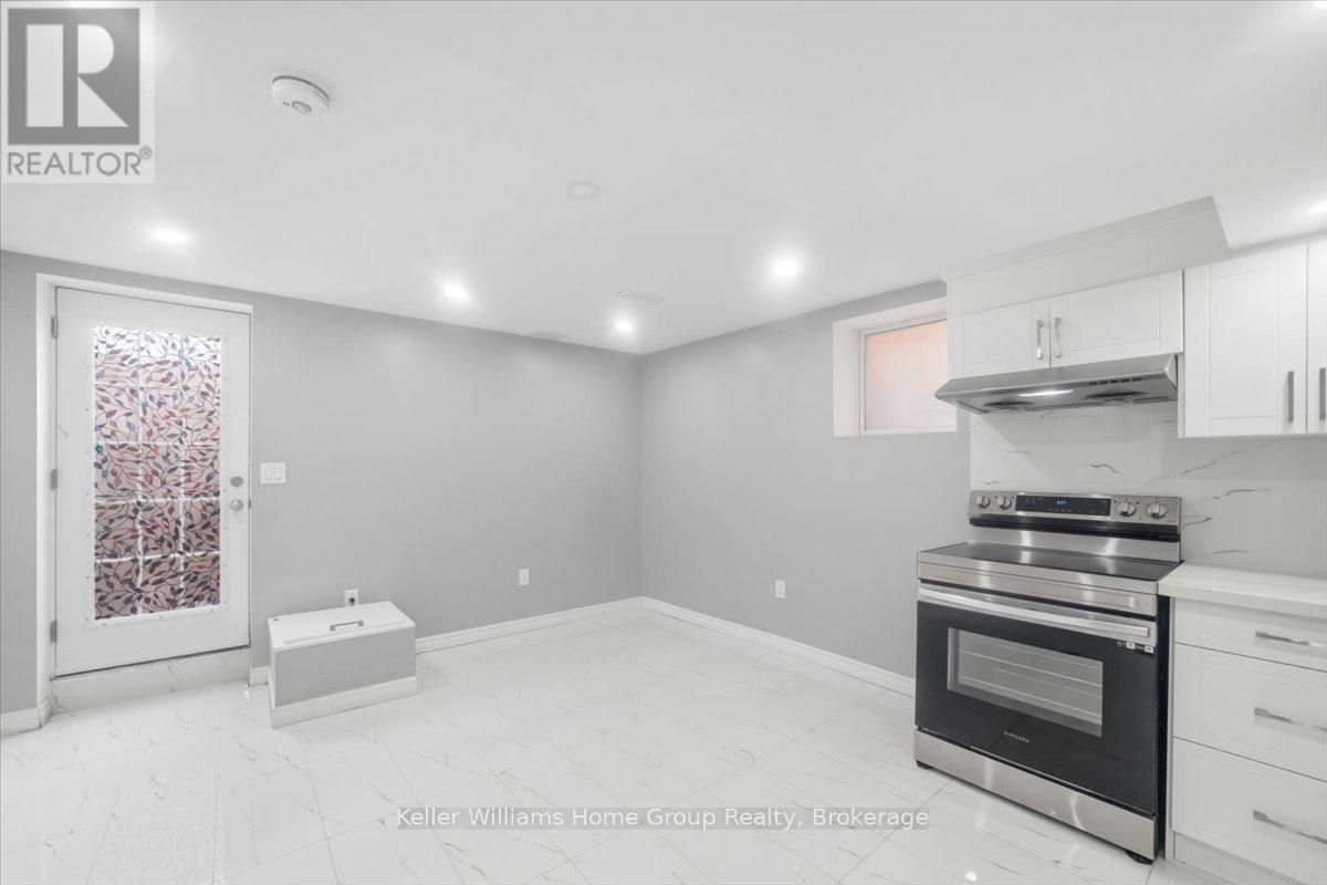 A kitchen with a stove top oven and a range hood.