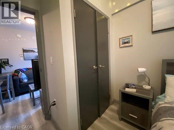 A bedroom with a bed, nightstand, and a wardrobe.