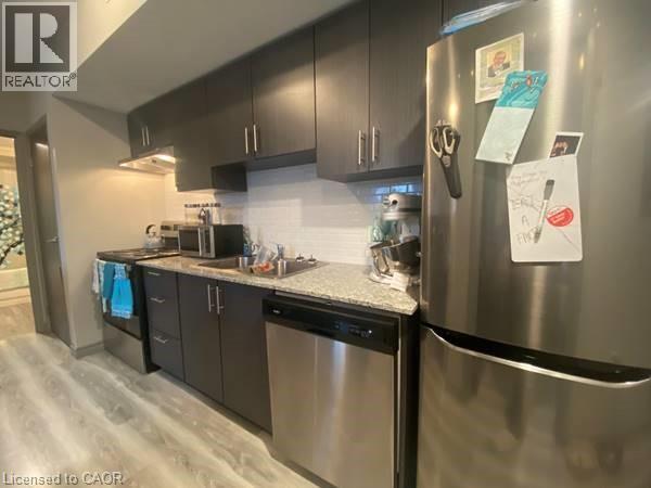 A kitchen with a refrigerator covered in papers.