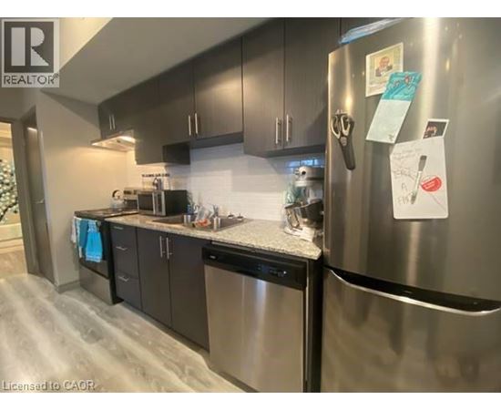 A kitchen with a refrigerator covered in papers.
