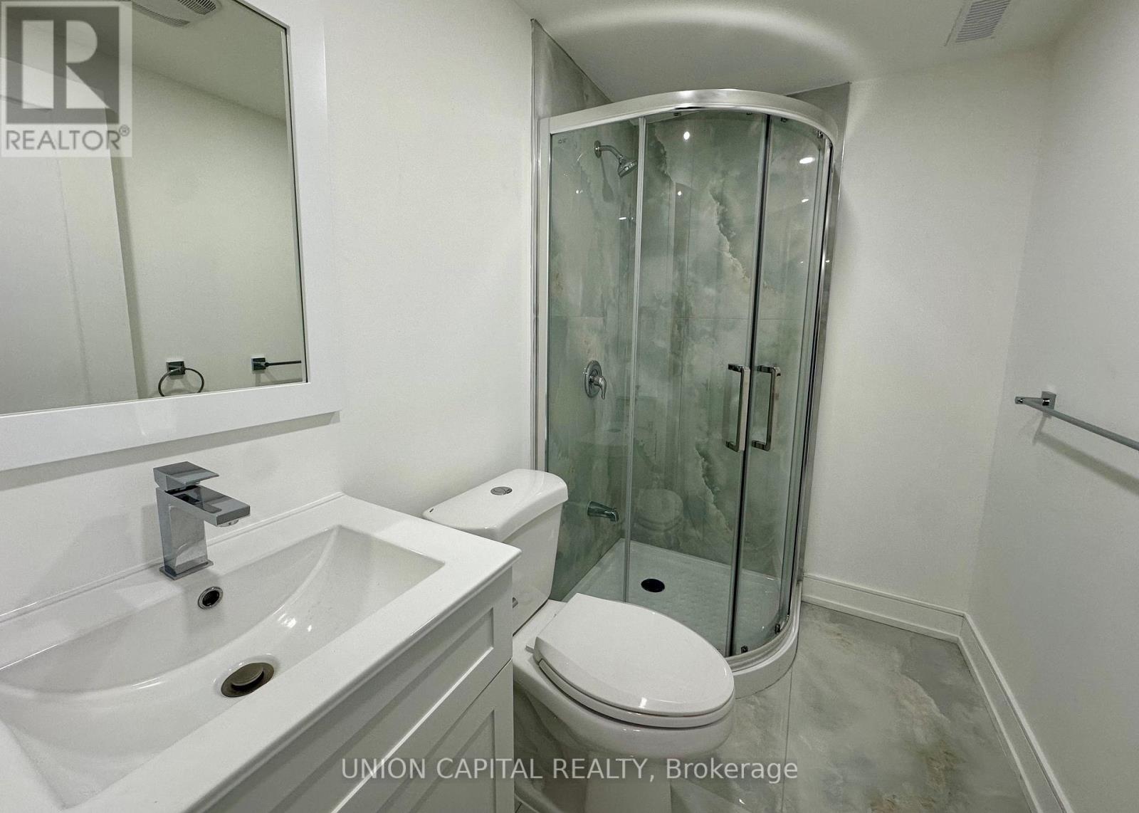 A white sink and toilet in a small bathroom.
