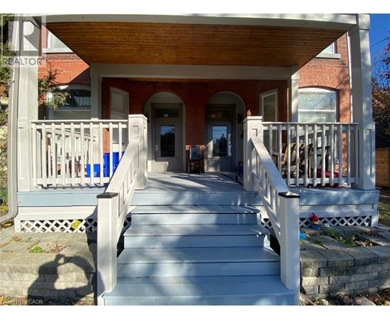 A porch with a table and chairs is shown.