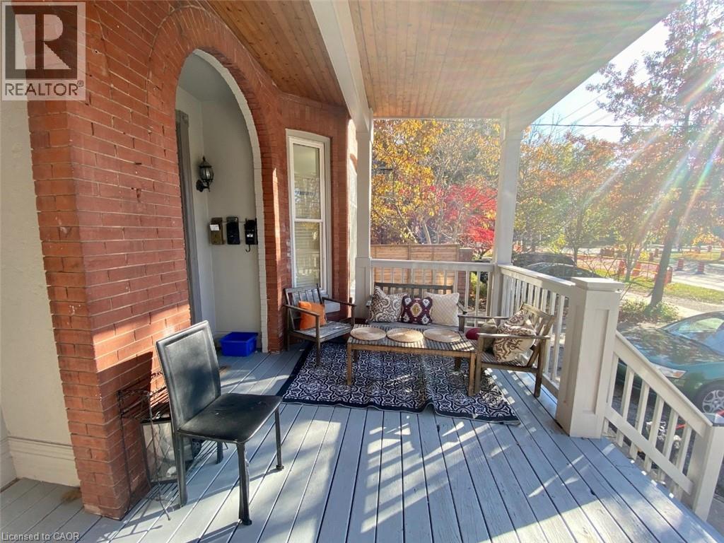A wooden deck with a black chair and a cushioned bench.