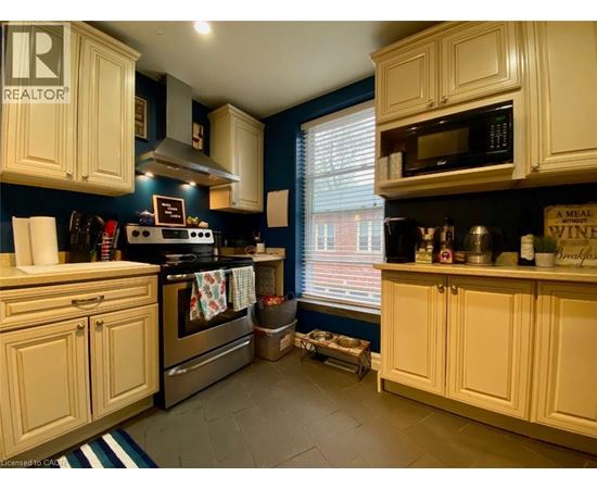 A room with wooden floors and a window with blinds.