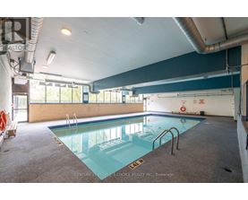 A large indoor swimming pool with a glass bottom.