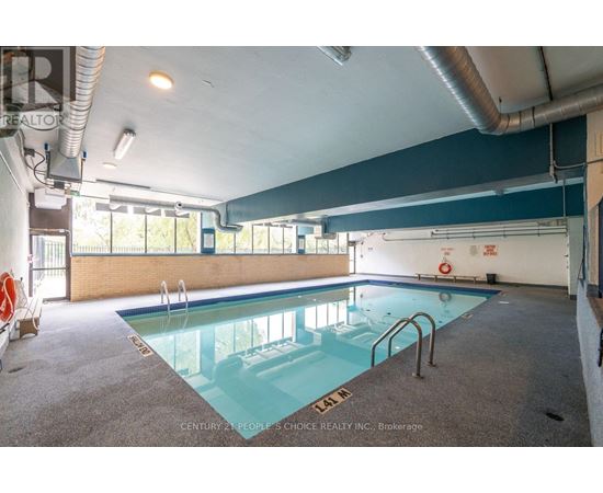 A large indoor swimming pool with a glass bottom.
